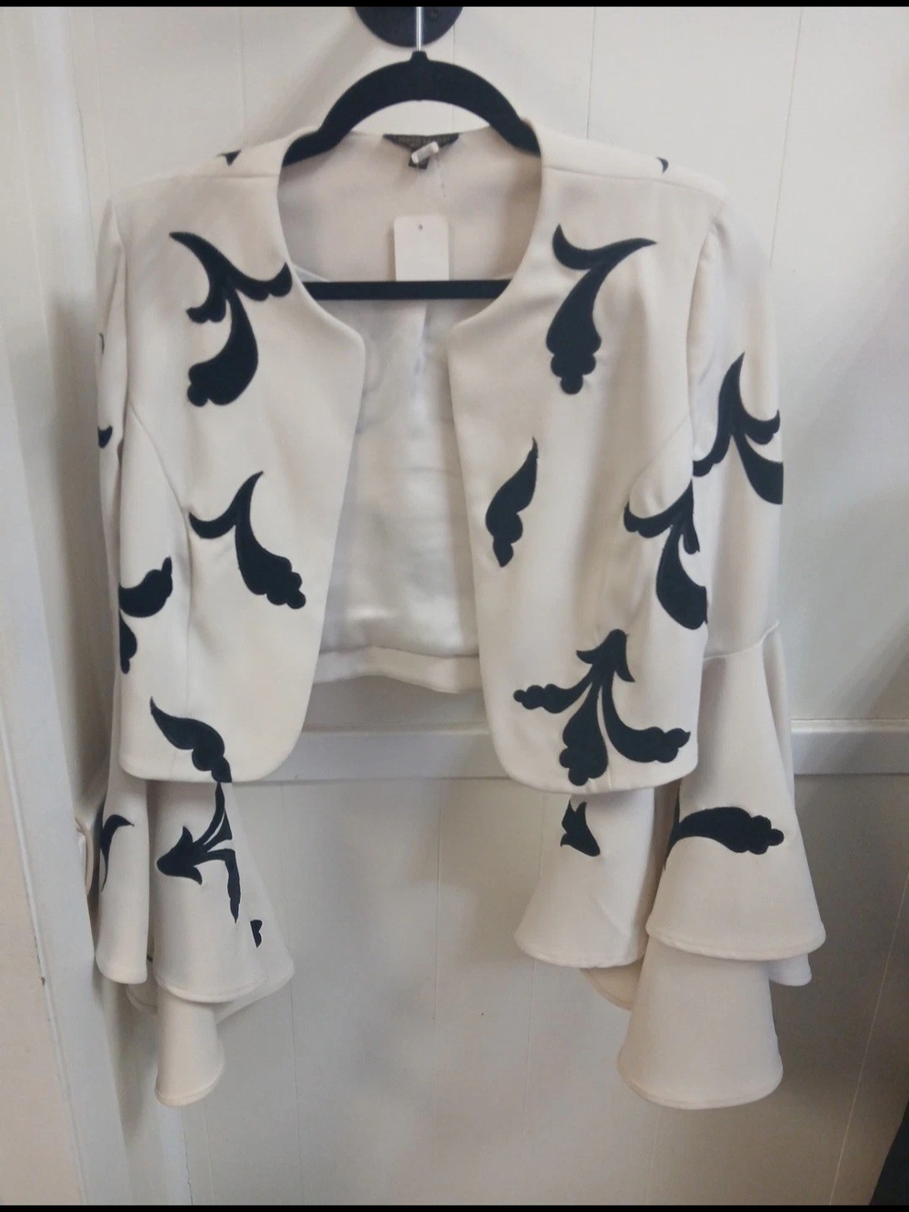 Alberto Makali Ivory Cropped Jacket with Bell Sleeves & Black Floral Appliqué
